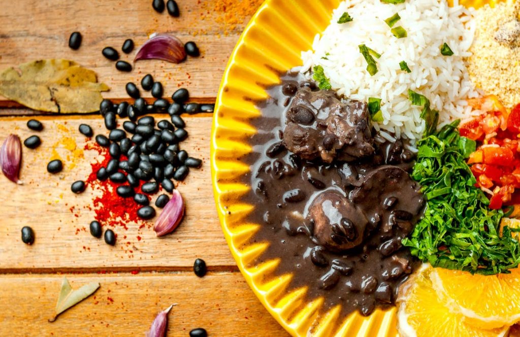 Image of Appetizing black bean stew with rice serves on table
