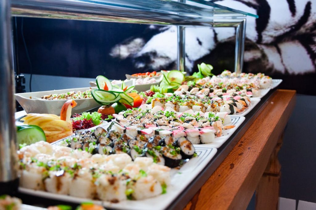 Image of Sushi on White Plates on Brown Wooden Table