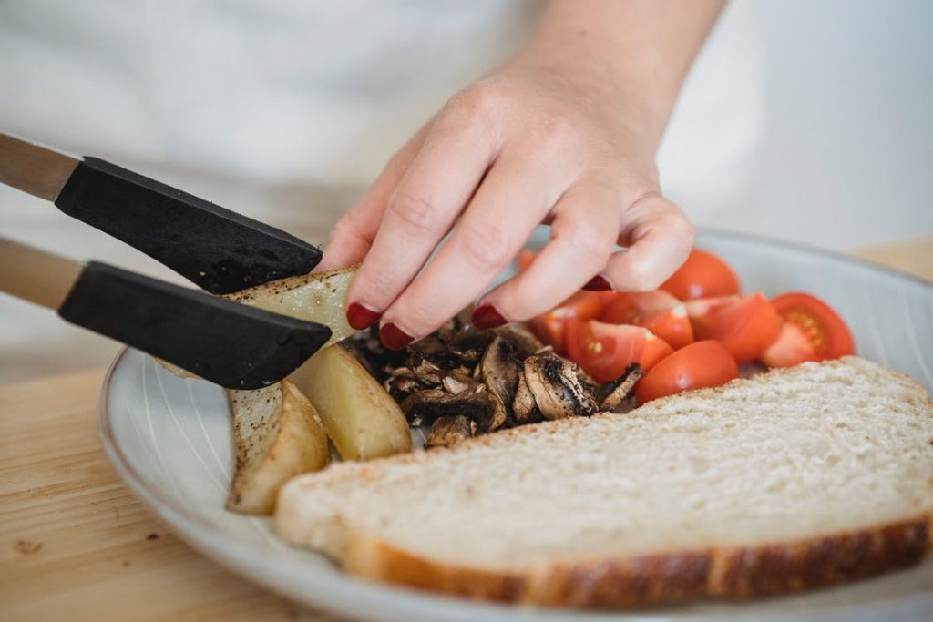 Image of Hand of a Person Arranging Potato Wedges