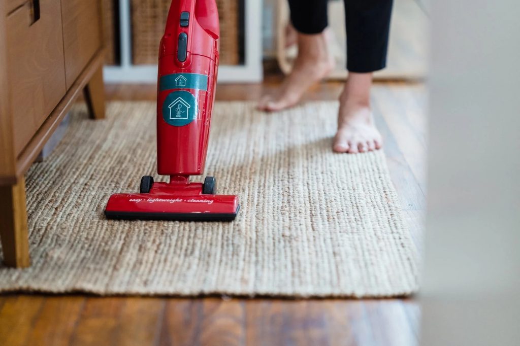 Image of A Person Vacuuming a Carpet