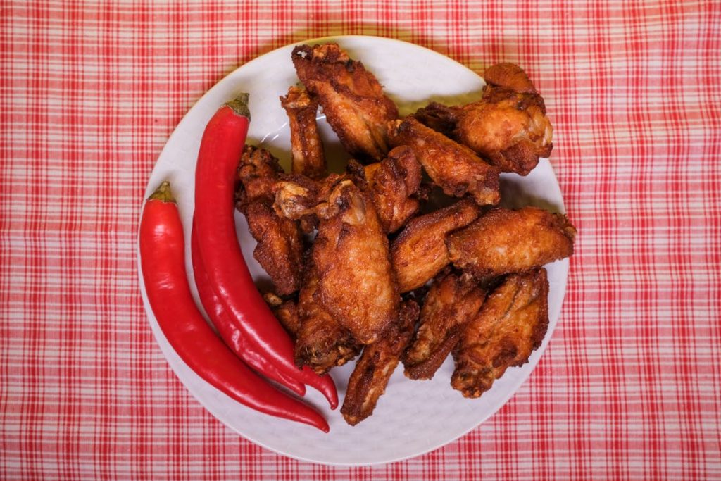 Image of Chili Peppers and Fried Chicken Wings on Plate