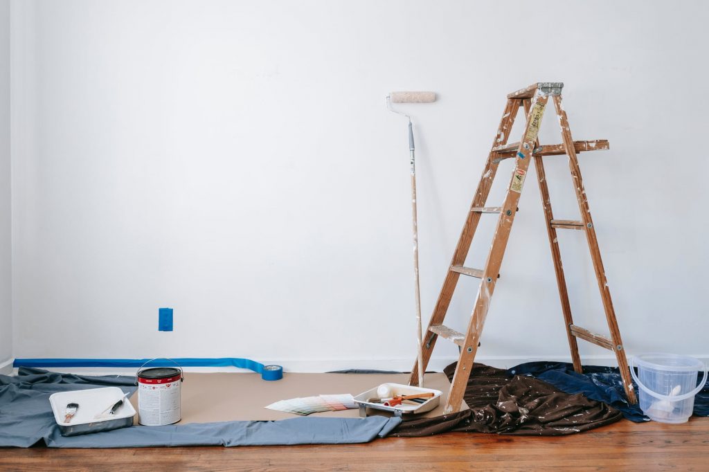 Image of Brown Wooden Ladder Beside Painting Materials