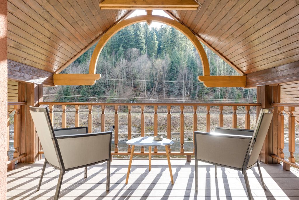 Image of Wooden Balcony on Attic with Steel Framed Chairs