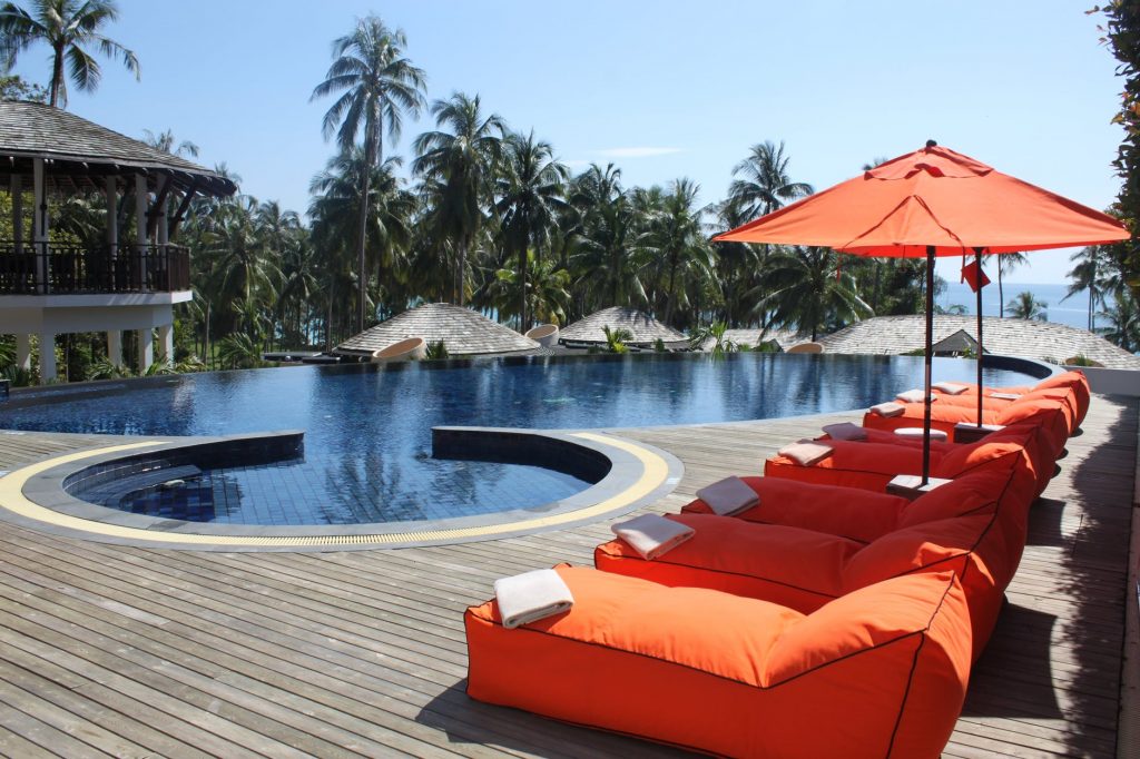Image of Orange Lounges Near Swimming Pool