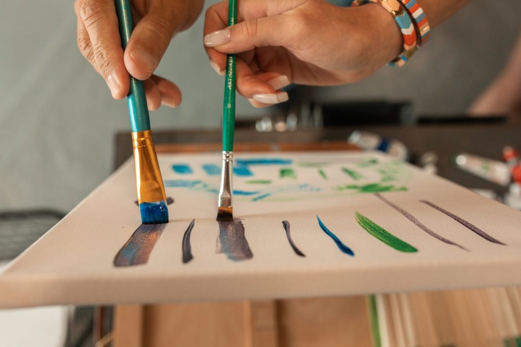 Image of People Holding A Paint Brush
