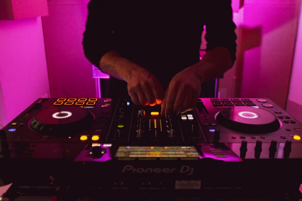 Image of Person in Black Long Sleeve Shirt Playing Dj Controller
