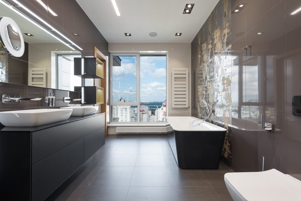 Image of Interior of modern bathroom with bathtub and big windows