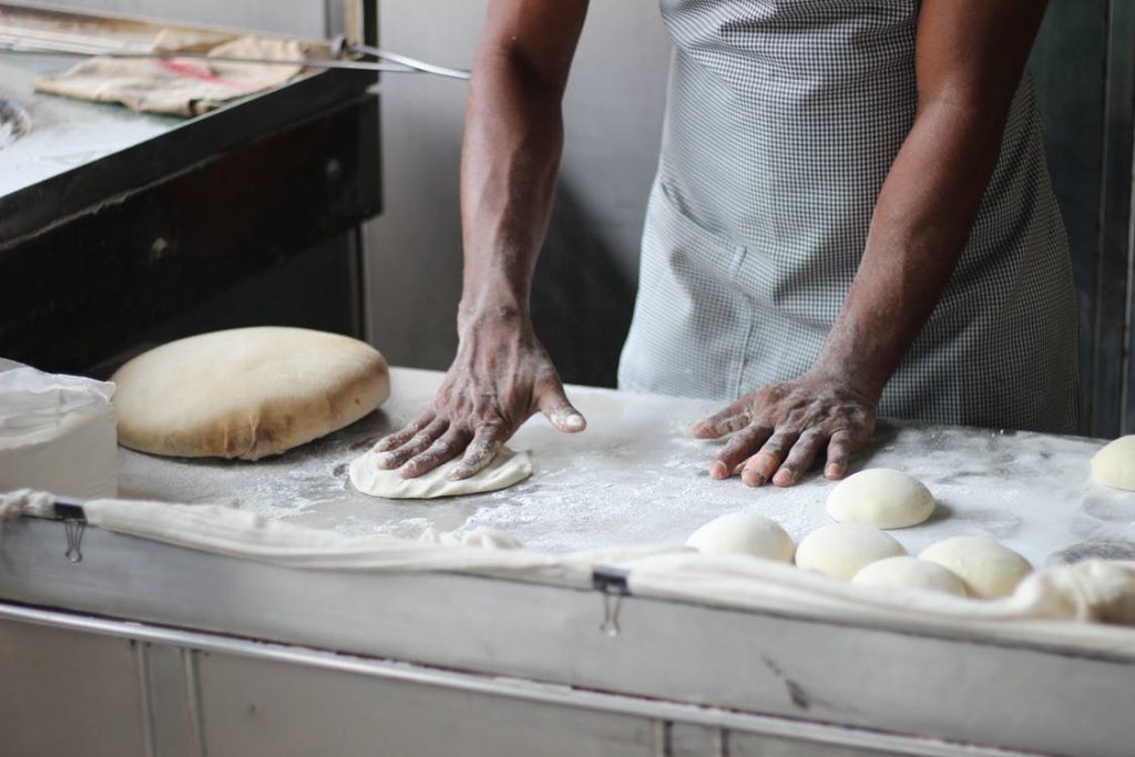 Image of Man Preparing Dough For Bread