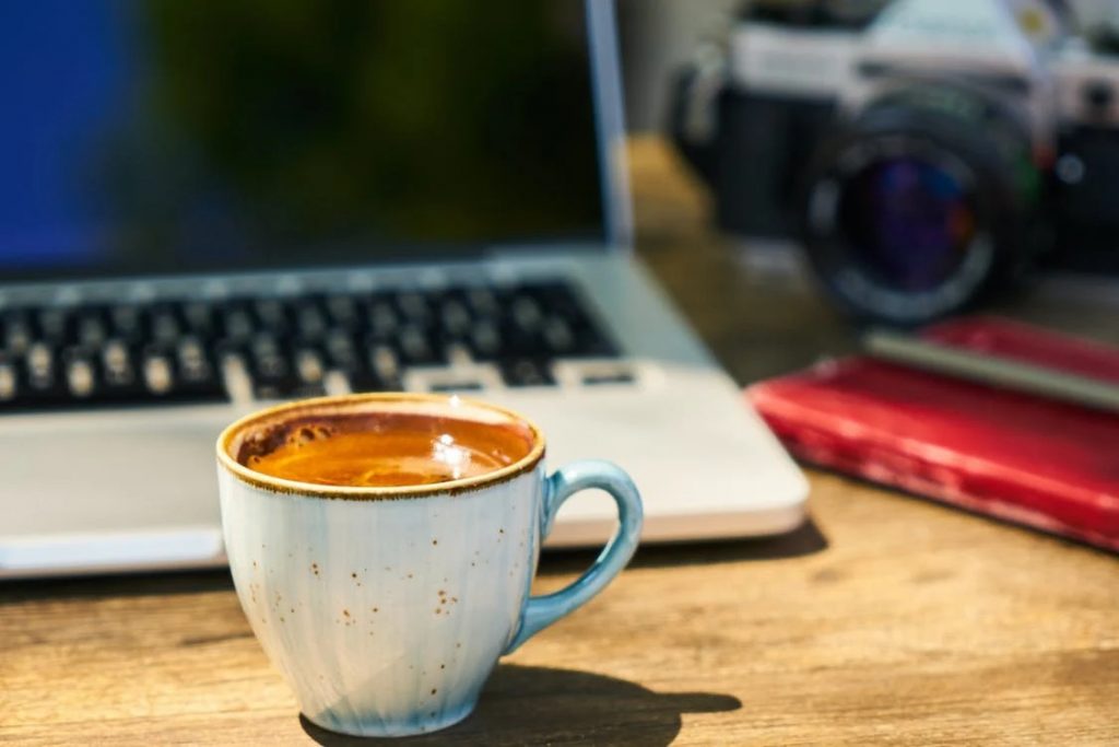 Image of cup of coffee and a laptop