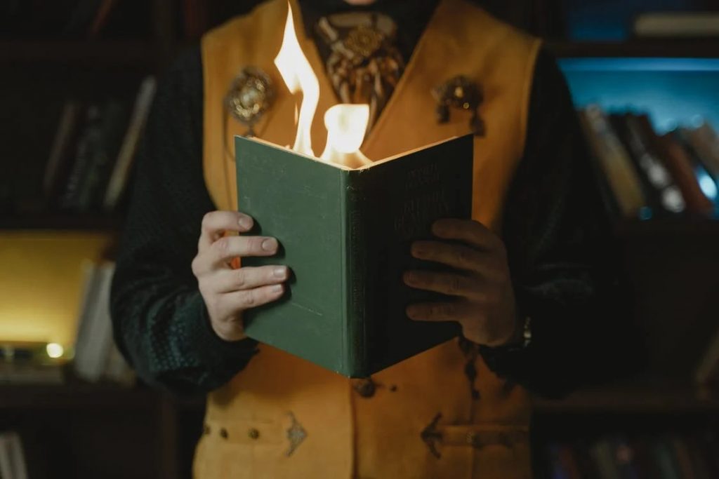 Image of A Person Holding a Book with Fire