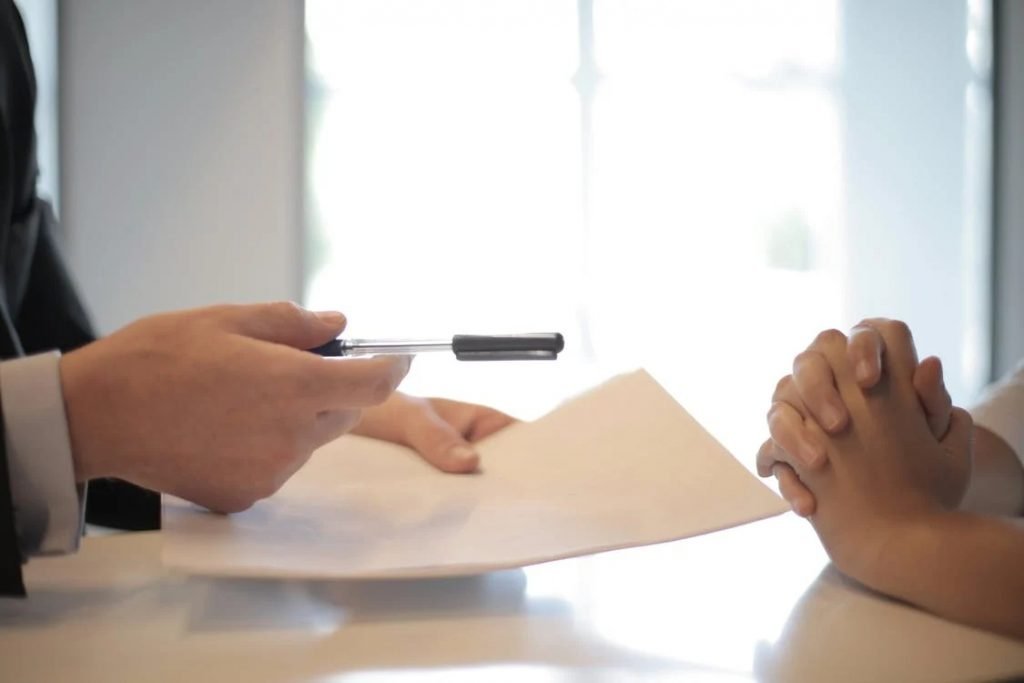 Image of giving contract to woman to sign