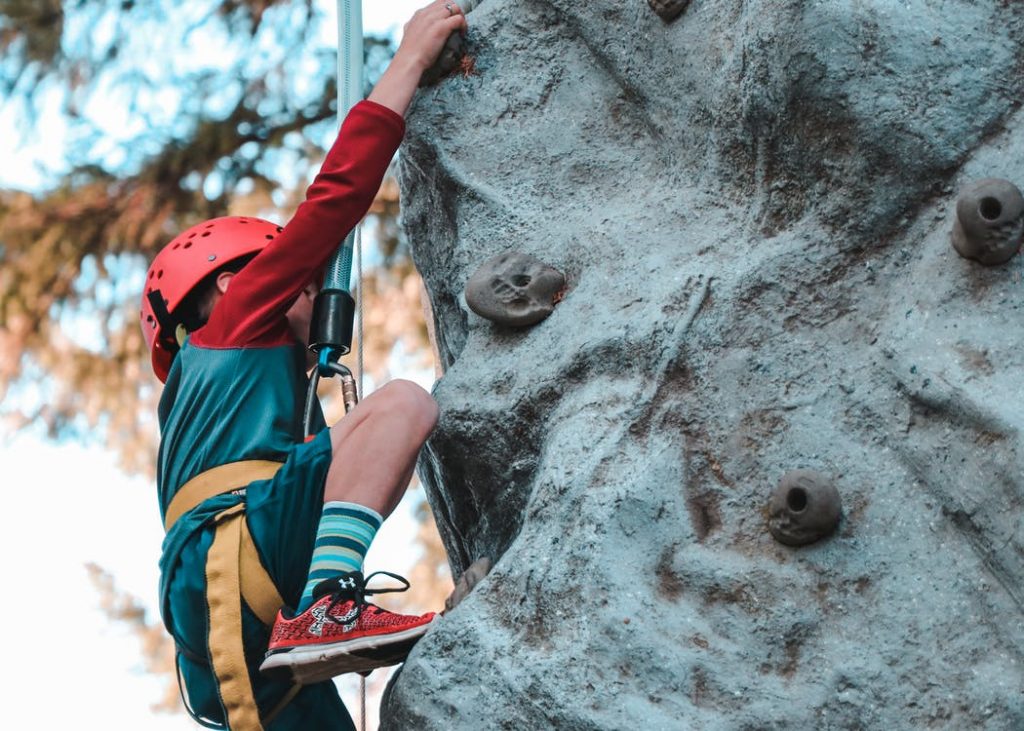 Image of Person Climbing on Gray Rock