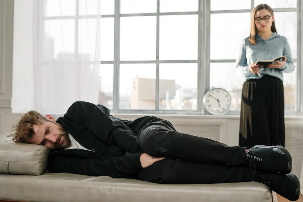 Image of Man in Black Jacket Lying on Bed