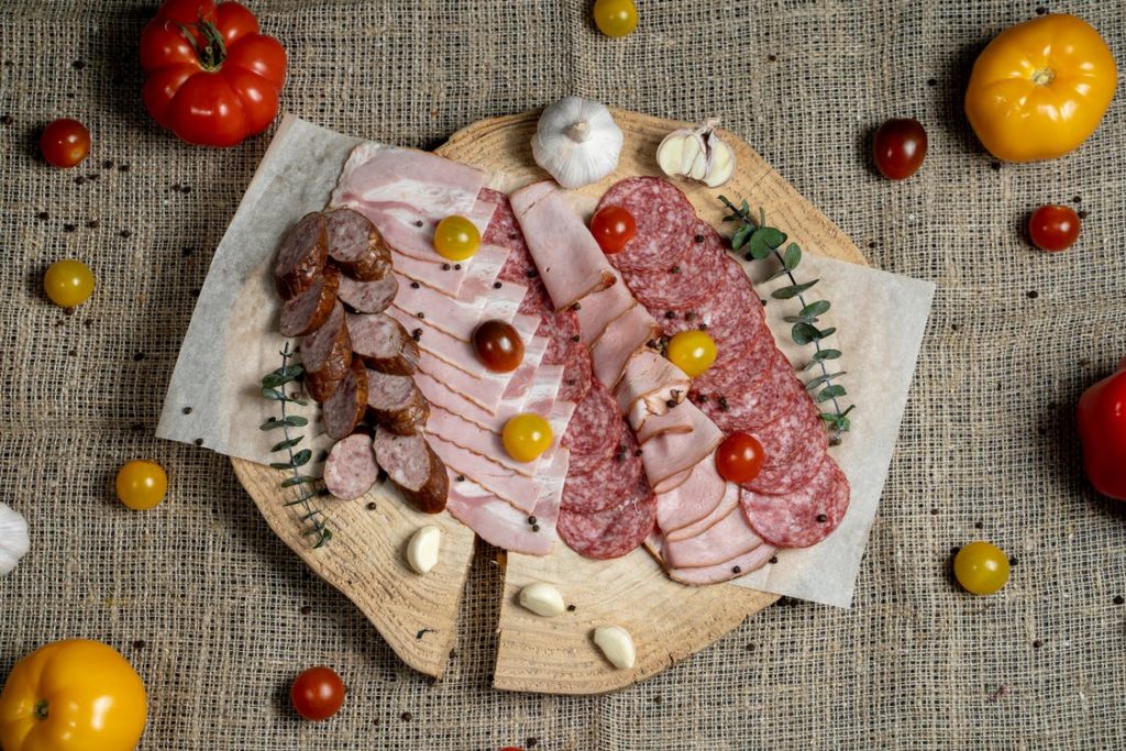Image of Ham and Tomato on Brown Wooden Round Plate