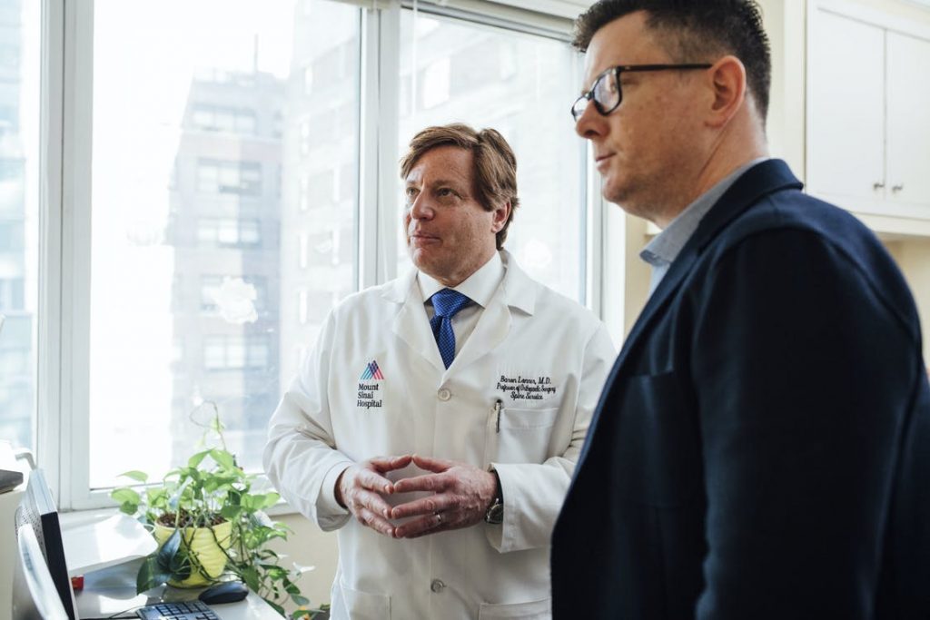 Image of Two Men Standing Inside a Room