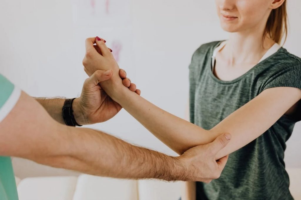 Image of chiropractor examining arm